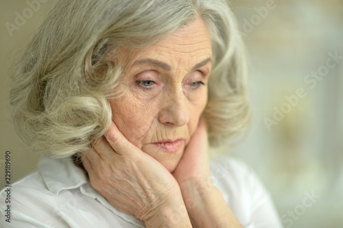 Close up portrait of tired senior woman