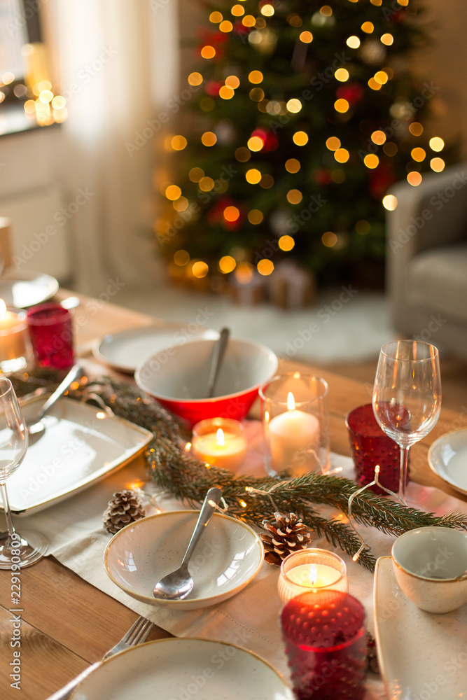 christmas, holidays and eating concept - table served for festive dinner at home christmas, holidays and eating concept - table served for festive dinner at home