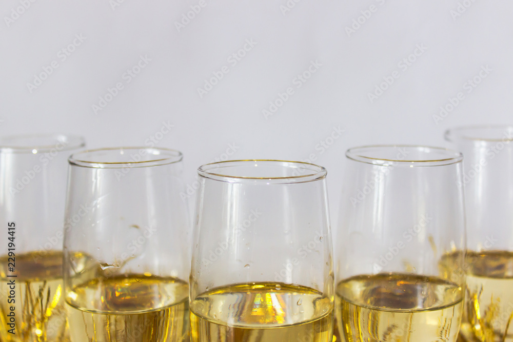 Glasses with champagne on the light gray background. New year or Christmas concept. Copy space. Glasses with champagne on the light gray background. New year or Christmas concept. Copy space.