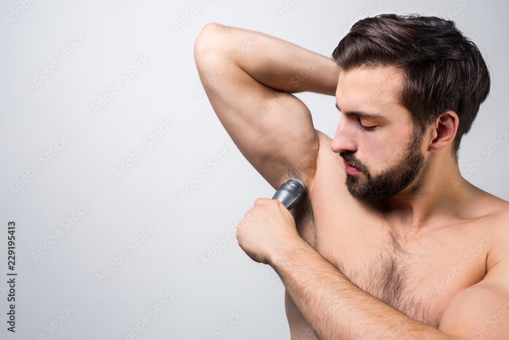 Close up of a guy that shaving some hair under his armpit. He is trying to do his best. Advertising concept. Cut view. Isolated on white background. Close up of a guy that shaving some hair under his armpit. He is trying to do his best. Advertising concept. Cut view. Isolated on white background.
