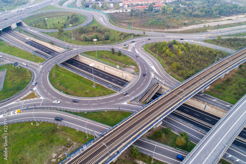 Aerial view of highway intersection with roundabout and railroad © Arcansél