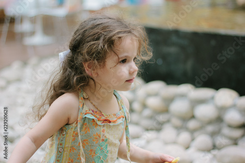Little girl eating french f...