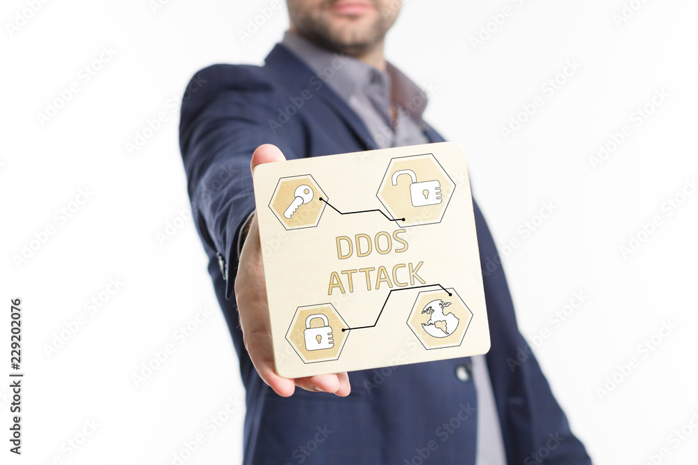The concept of business, technology, the Internet and the network. Young businessman showing inscription: Ddos attack The concept of business, technology, the Internet and the network. Young businessman showing inscription: Ddos attack