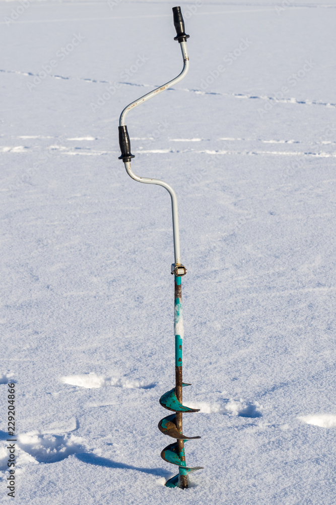 ice drill tool winter fisherman. winter fishing. winter on the lake.