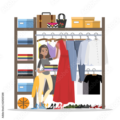 Smiling woman choosing clothes in the wardrobe