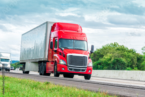 Red Eighteen Wheeler Travels Interstate Highway