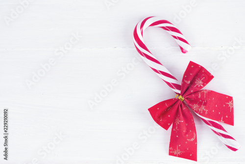 Christmas composition. Christmas candy cane on wooden white background. Flat lay, top view, copy space, background.