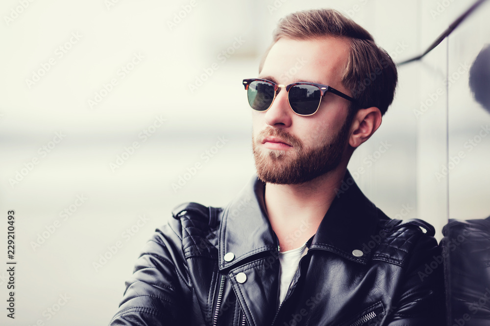 Obraz premium portrait of sexy handsome fashion male model man dressed leather jacket