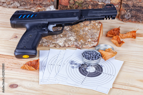 A airgun with its pellets and targets to practice the shot photo