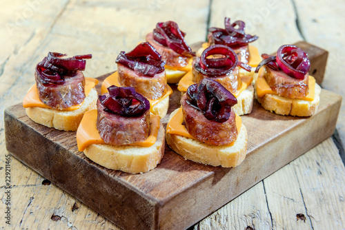 Croutons of bread with cheese sausage and caramelized onion photo
