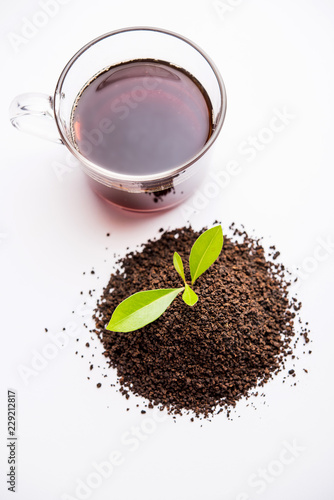 Black Tea Powder or dry dust with or without green leaf and served hot chai in a cup