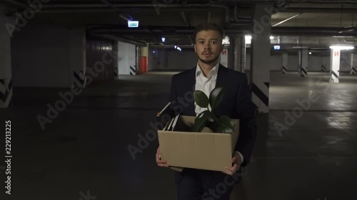 Wallpaper Mural Very Emotional disappointed Corporate worker gets fired and walking down parking lot with carton box and documents with a table flower. Almost crying. Torontodigital.ca