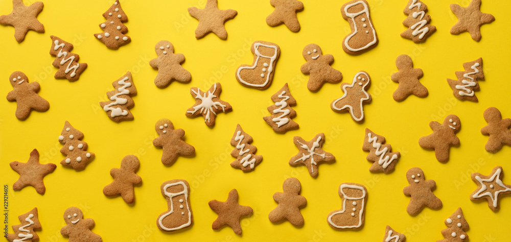 Christmas gingerbread cookies on yellow background. Banner. Top view, copy space. New year concept Christmas gingerbread cookies on yellow background. Banner. Top view, copy space. New year concept