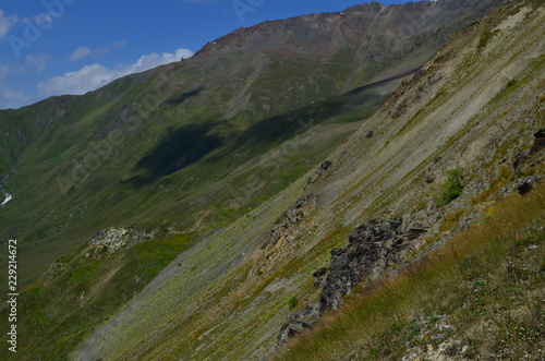 steep slope and shade of clouds and blue sky