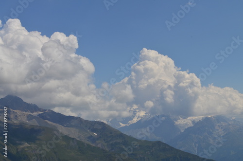 cumulus clouds over a large mountain glacier