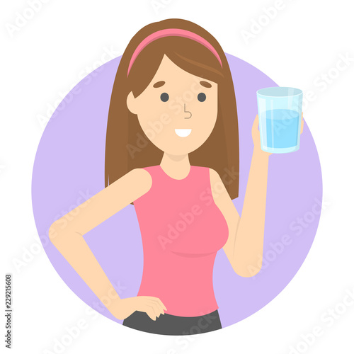 Young smiling woman holding a glass of fresh cold water.