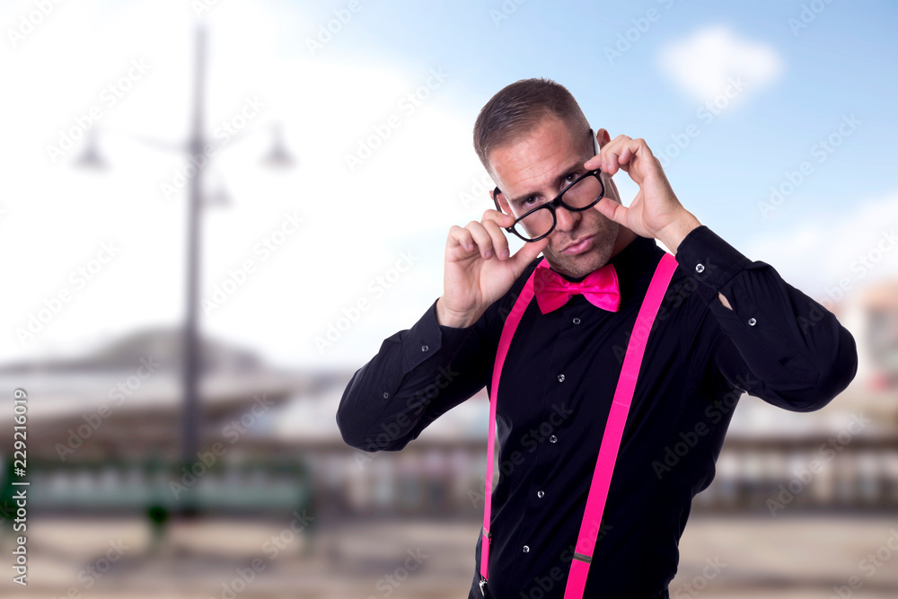 Young boy with black shirt and bow tie and colored suspenders Young boy with black shirt and bow tie and colored suspenders