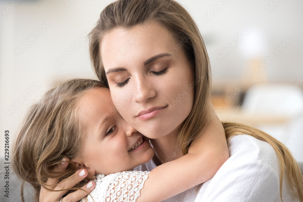Cute little girl hug young mom, touching her face, showing love and care, millennial mother embrace small daughter, feeling sweet tender moment, enjoying time together. Family relationships concept Cute little girl hug young mom, touching her face, showing love and care, millennial mother embrace small daughter, feeling sweet tender moment, enjoying time together. Family relationships concept