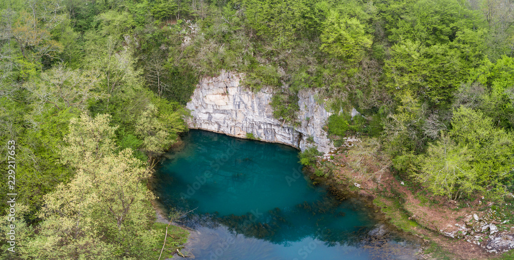 Krupa Spring (Izvir Krupa) in Bela Krajina, southern Slovenia, is a big karst spring below rock wall. It is protected as natural heritage and special habitat of water spices.