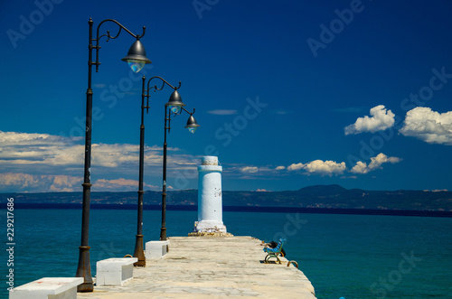 White pier jetty on blue paradise water, Kassandra, Macedonia, Greece photo