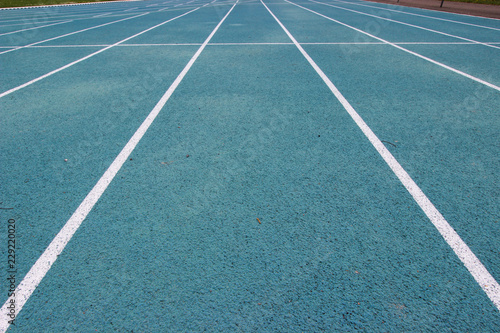 running racetrack with white lines on blue ground © Nicolas