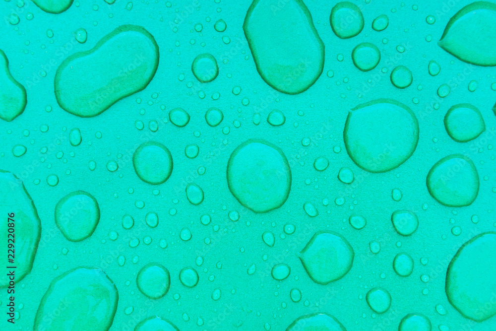 Drops of water on a green background, texture
