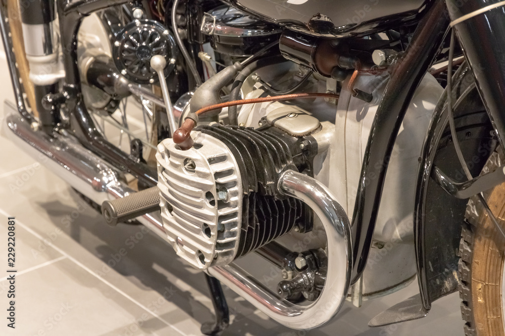 Vintage motorcycle. Engine and chrome pipe close-up.