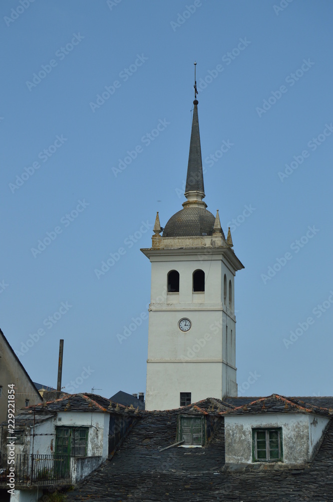 Bell Tower Of The Santiago Apostol Church And Houses With Very Old Roofs Practically Broken In Castropol. August 2, 2018. Architecture, Nature, Travel. Castropol, Asturias, Spain.