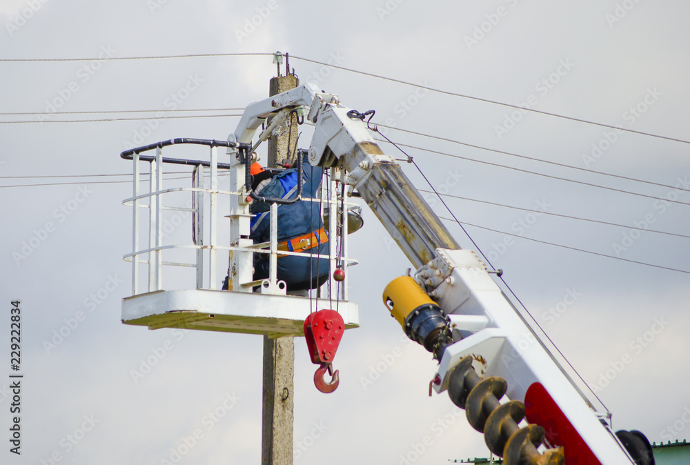 the man repairs at an altitude of wires, post. the man repairs at an altitude of wires, post.