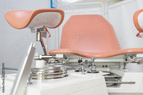 Gynecological cabinet with chair and other medical equipment in modern clinic