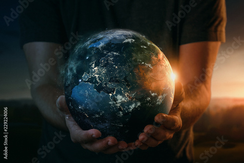 Planet earth in human hands. Elements of this image furnished by NASA