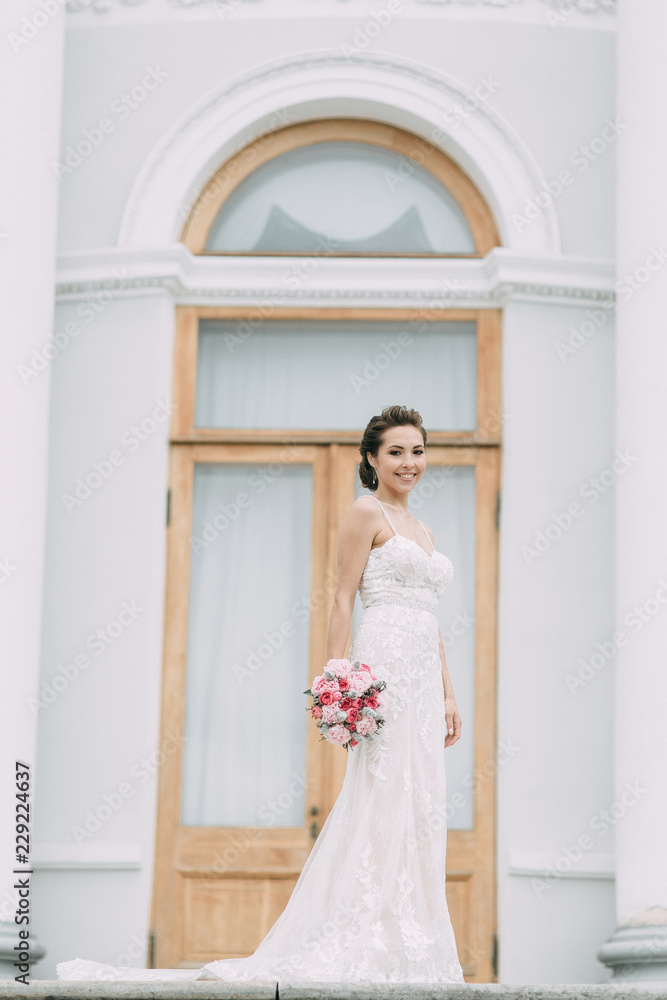 Fototapeta premium Beautiful bride at the castle on the street. Shooting on Elagin island. Russian wedding in St. Petersburg.