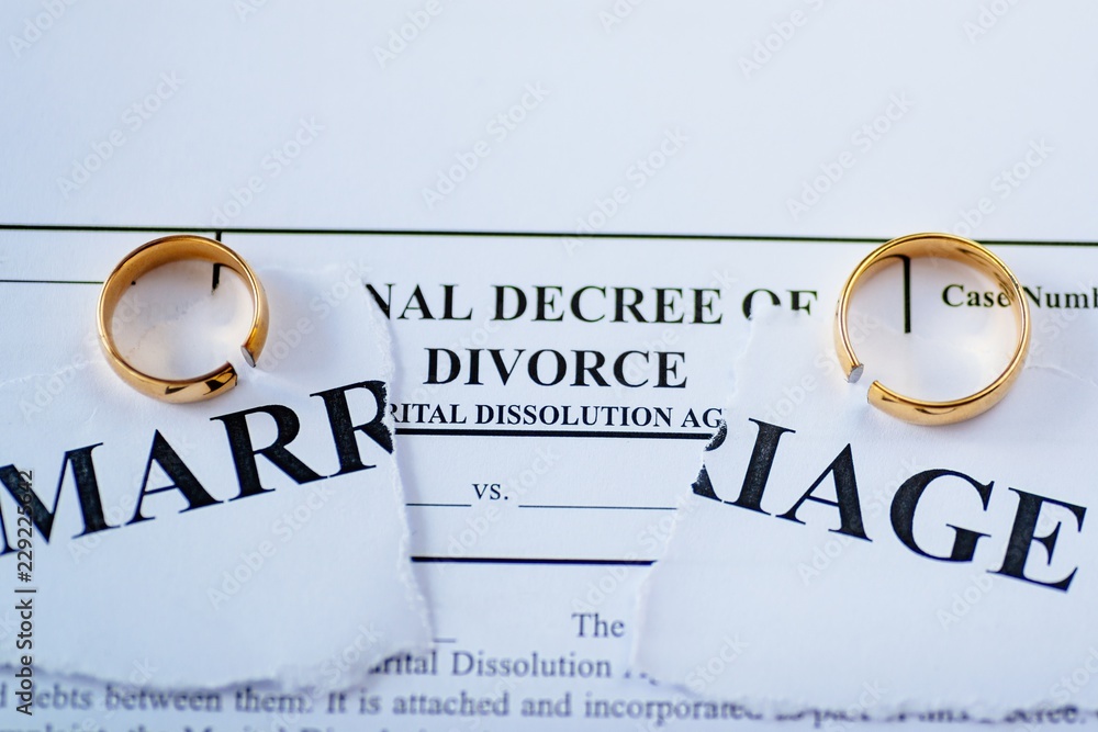 Divorce decree and two broken wedding rings