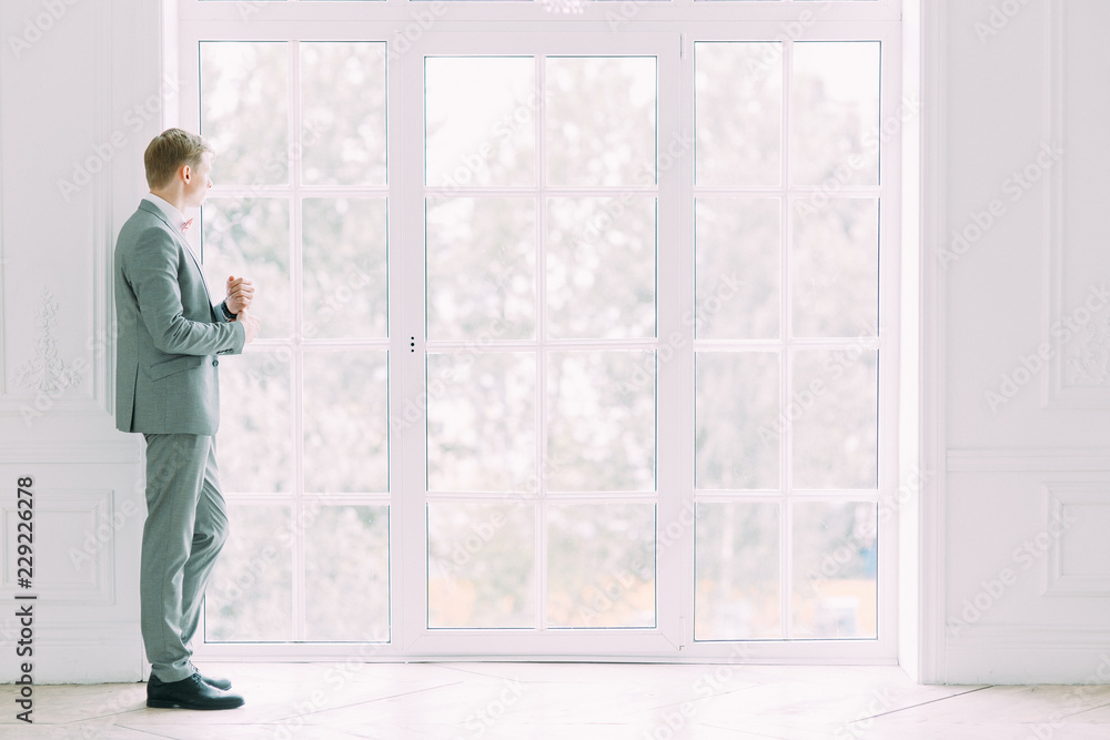 Stylish modern groom before the wedding. Portrait of a man in a suit. Stylish modern groom before the wedding. Portrait of a man in a suit.