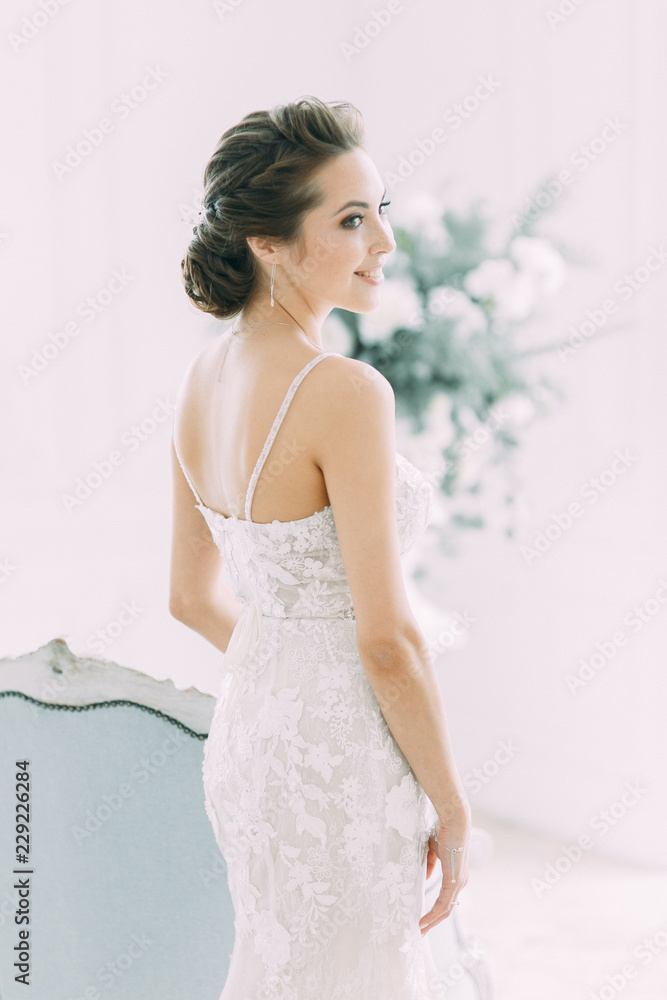 Beautiful bride in a white Studio. Russian wedding in St. Petersburg. Portrait and details in fine art style.