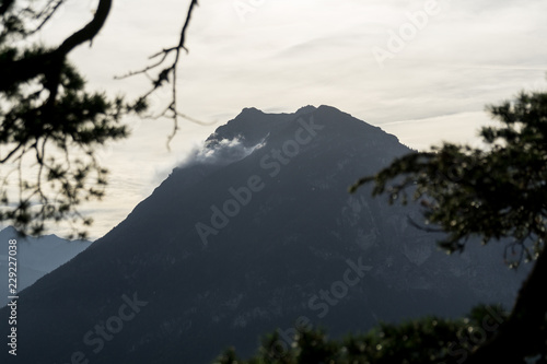 Mountain silhouette with forest and cloudy sky