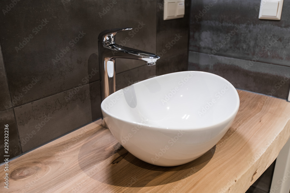 Fototapeta premium White top ceramic washbasin with glossy metal mixer