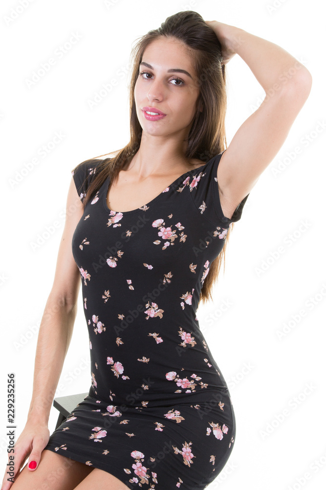 Beautiful young woman looking at camera with hand on head over white background