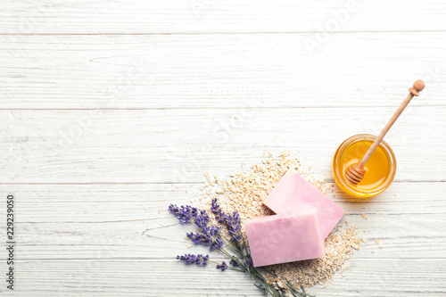 Fototapeta Naklejka Na Ścianę i Meble -  Flat lay composition with handmade soap bars and space for text on wooden background