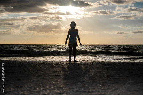kid jumping silhouette sunset beach