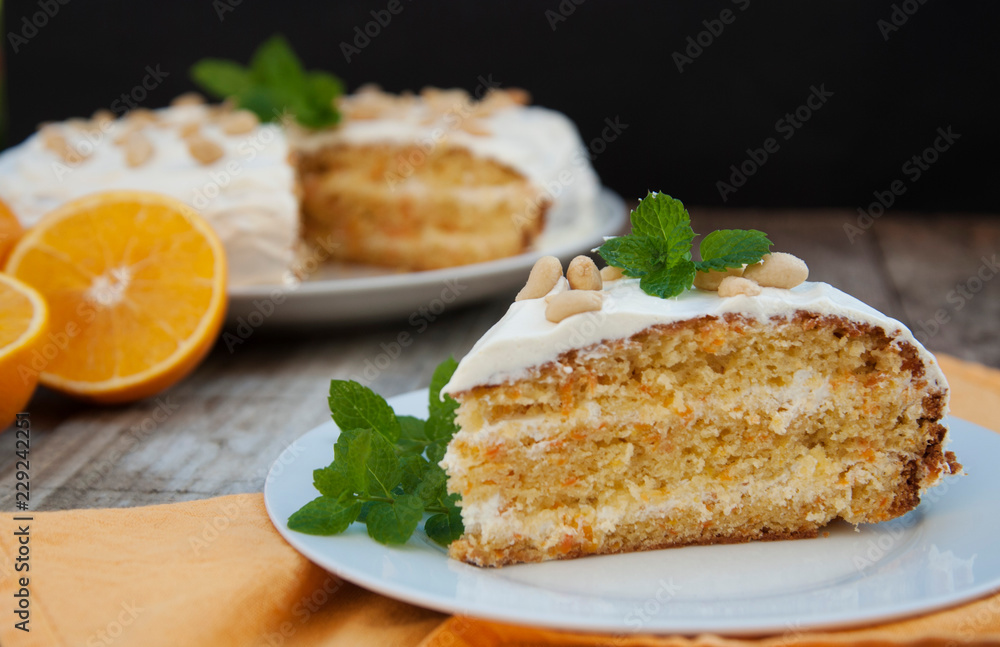 Orange and carrot cake, wooden background. Rustic style. Orange and carrot cake, wooden background. Rustic style.