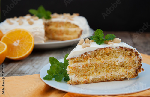 Orange and carrot cake, wooden background. Rustic style.