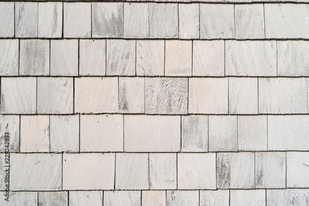 Naklejka premium Rows of cedar shingles painted with beige paint.