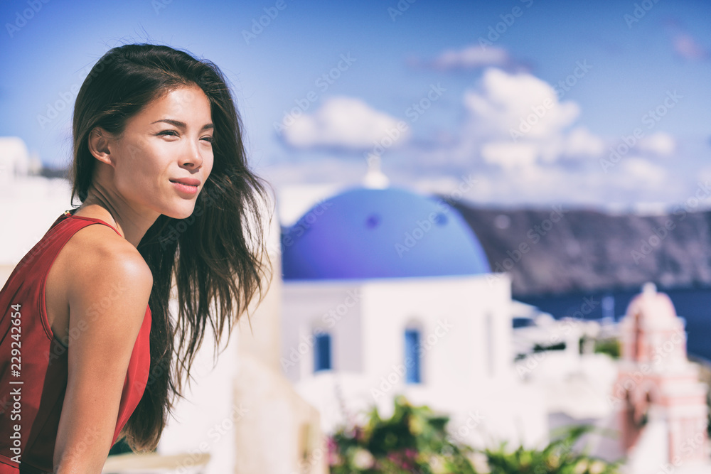 Luxury Europe cruise travel vacation Santorini woman looking at view. Tourist Asian girl relaxing at three blue domes, Oia, Greece, european destination.