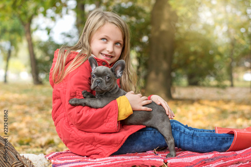 Little girl with Buldog puppy