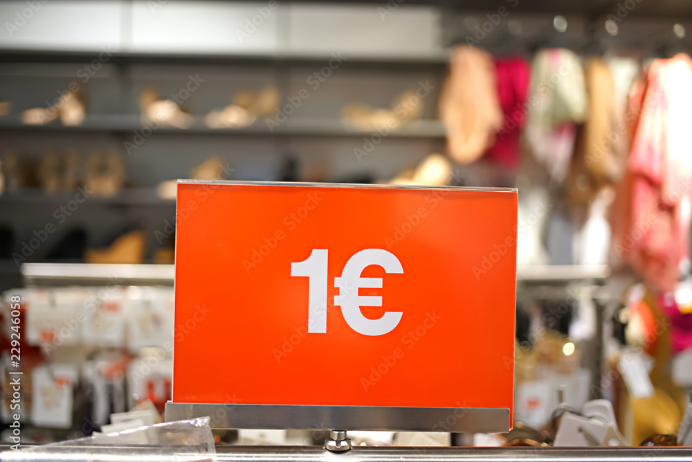 price one euro - inscription on a red background on the price tag in a clothing store during the sale price one euro - inscription on a red background on the price tag in a clothing store during the sale