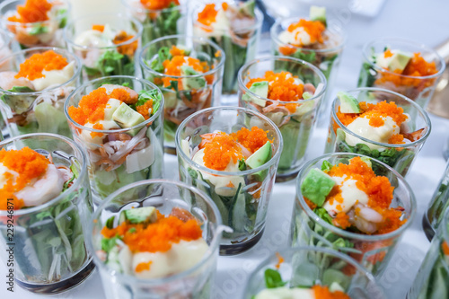 Party catering Cocktail food on a mini dish and tiny glass bowls.