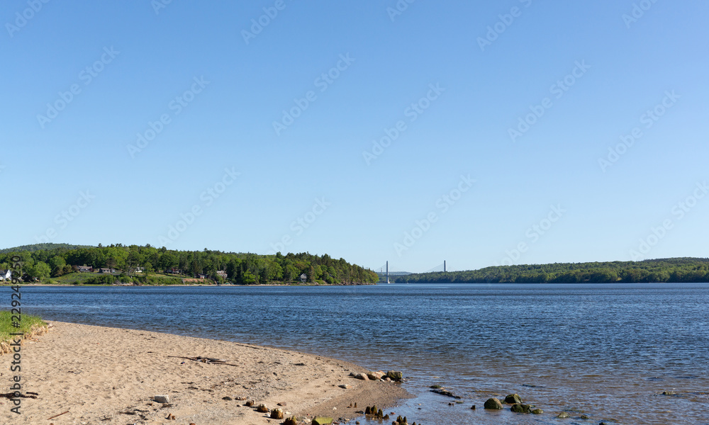 View Sandy Point Beach Park in Stockton Springs, Maine on a bright sunny morning with a distant
