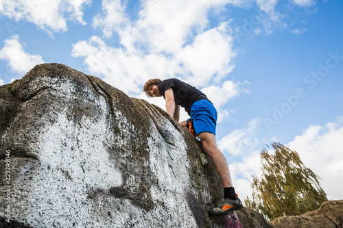 Climbing man on a hill in the park