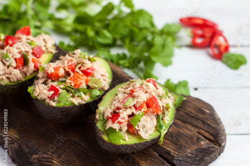 Avocados stuffed with canned tuna and vegetables photo
